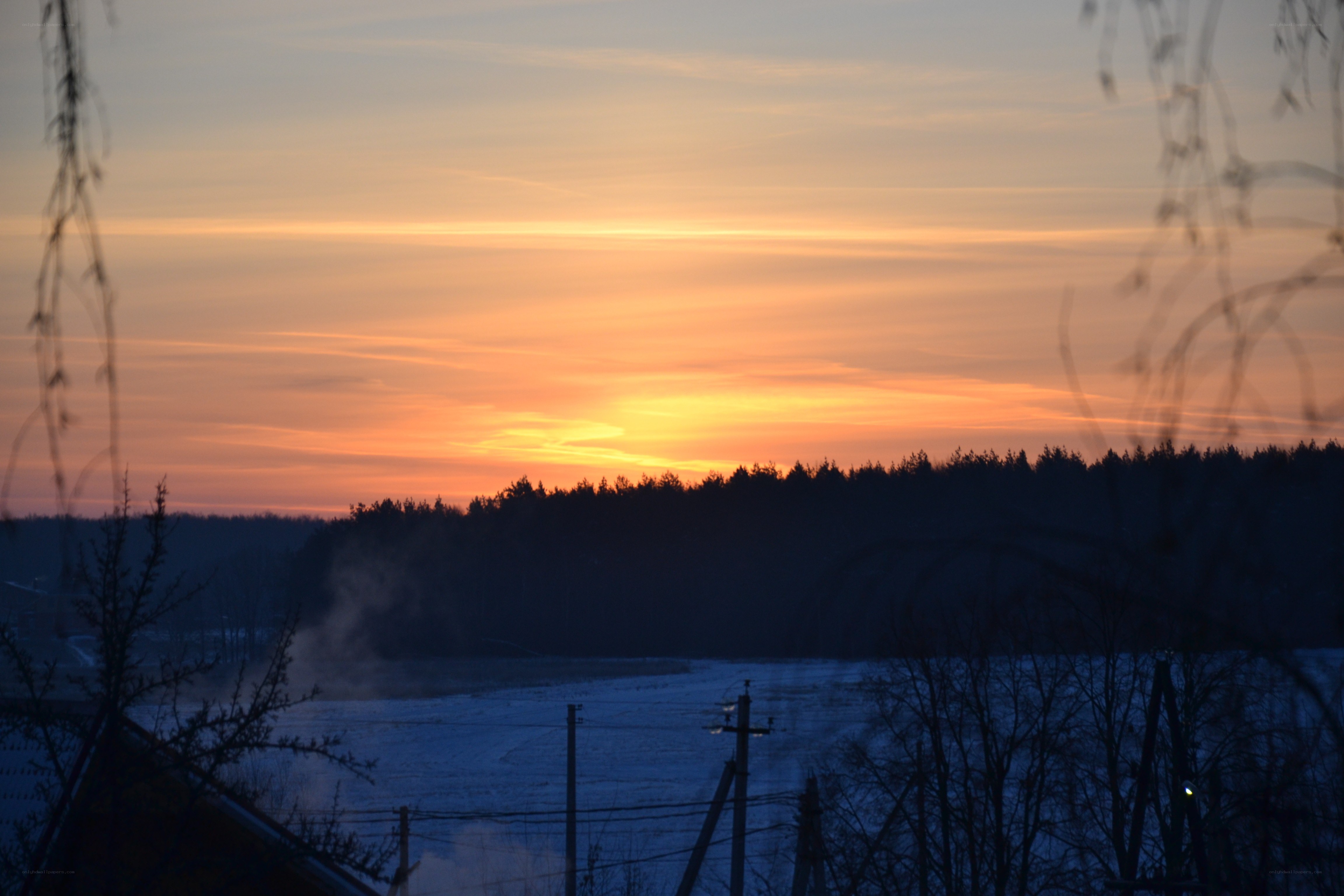 sunset over snowy landscape