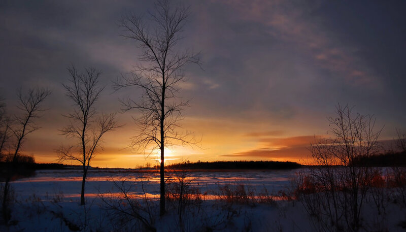 sunset over snowy landscape