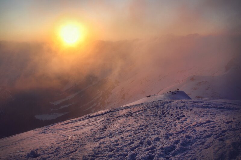 Sunset over snowy mountain peak