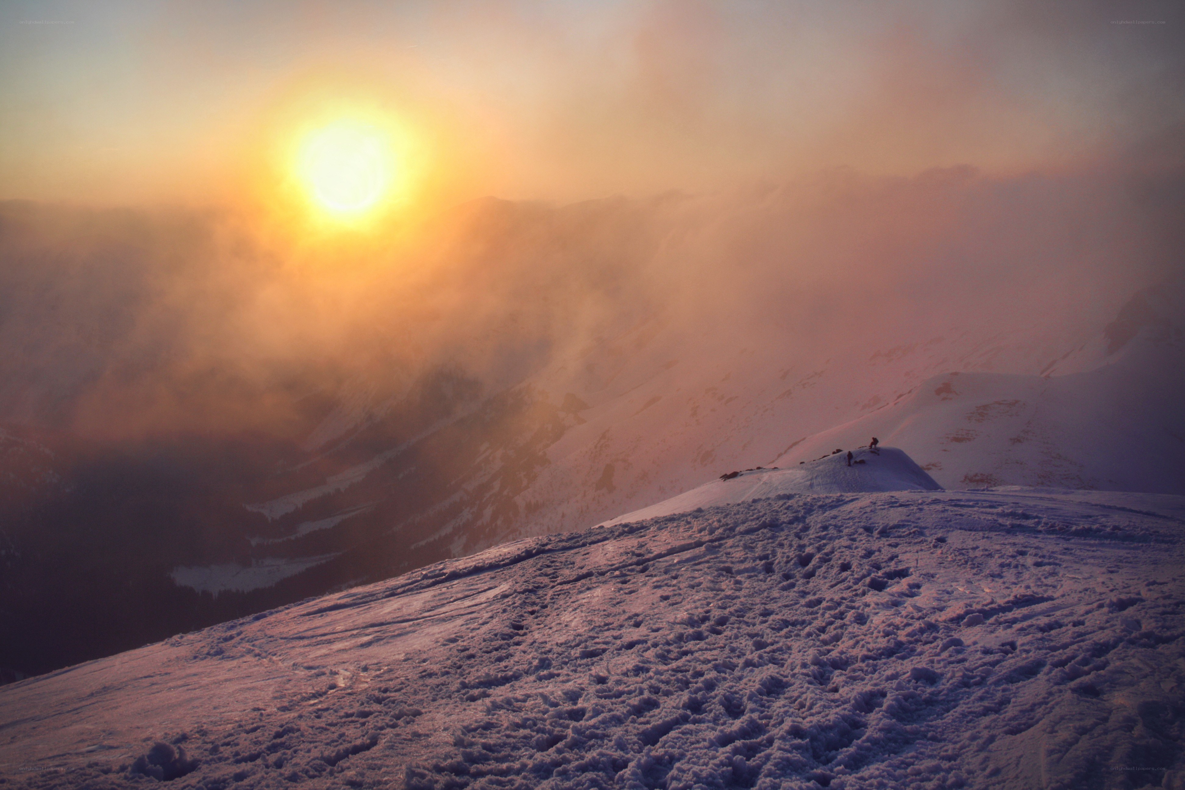 Sunset over snowy mountain peak