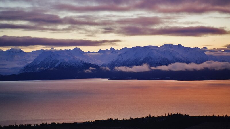 sunset over snowy mountains