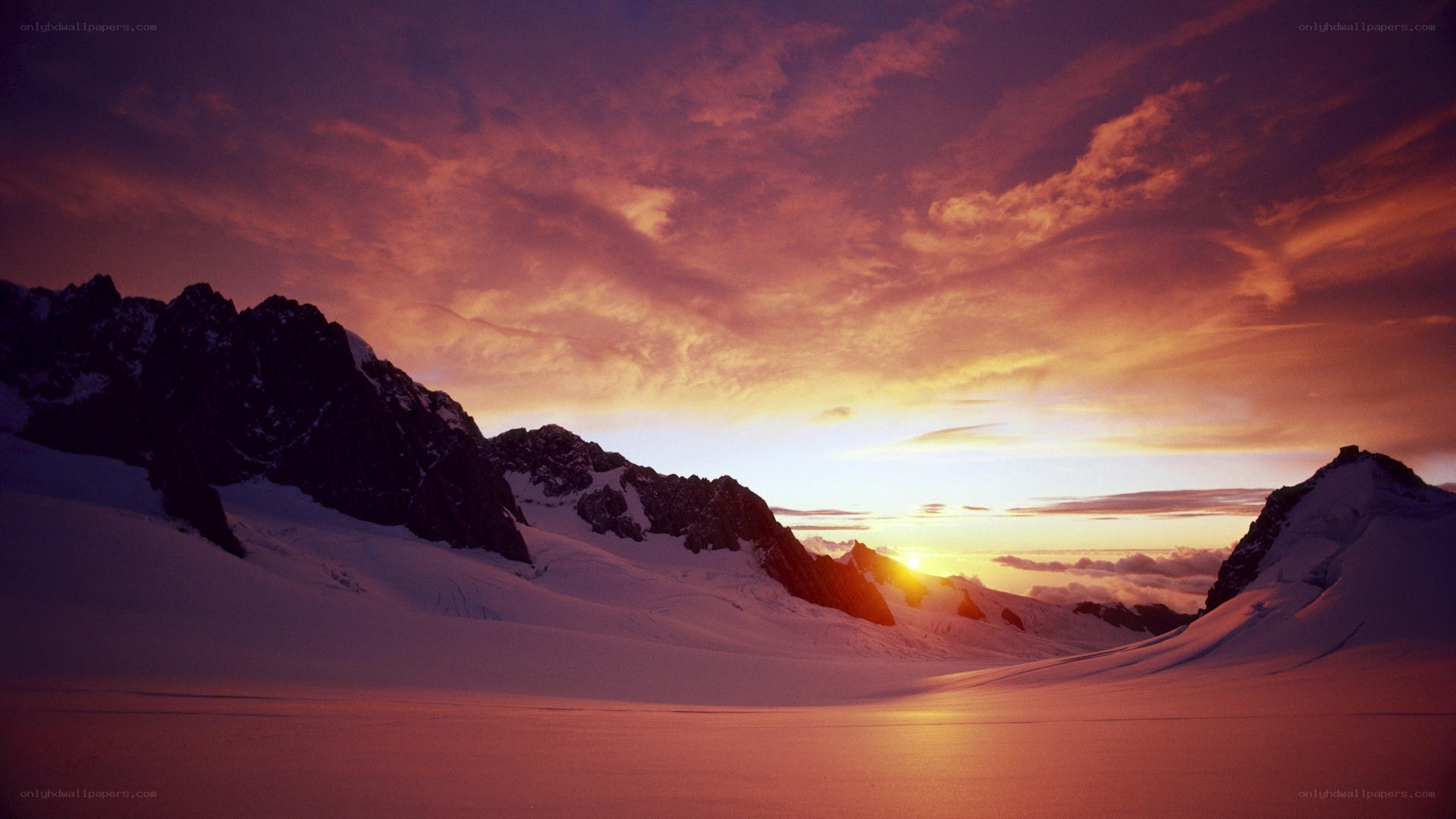 Sunset over snowy mountains