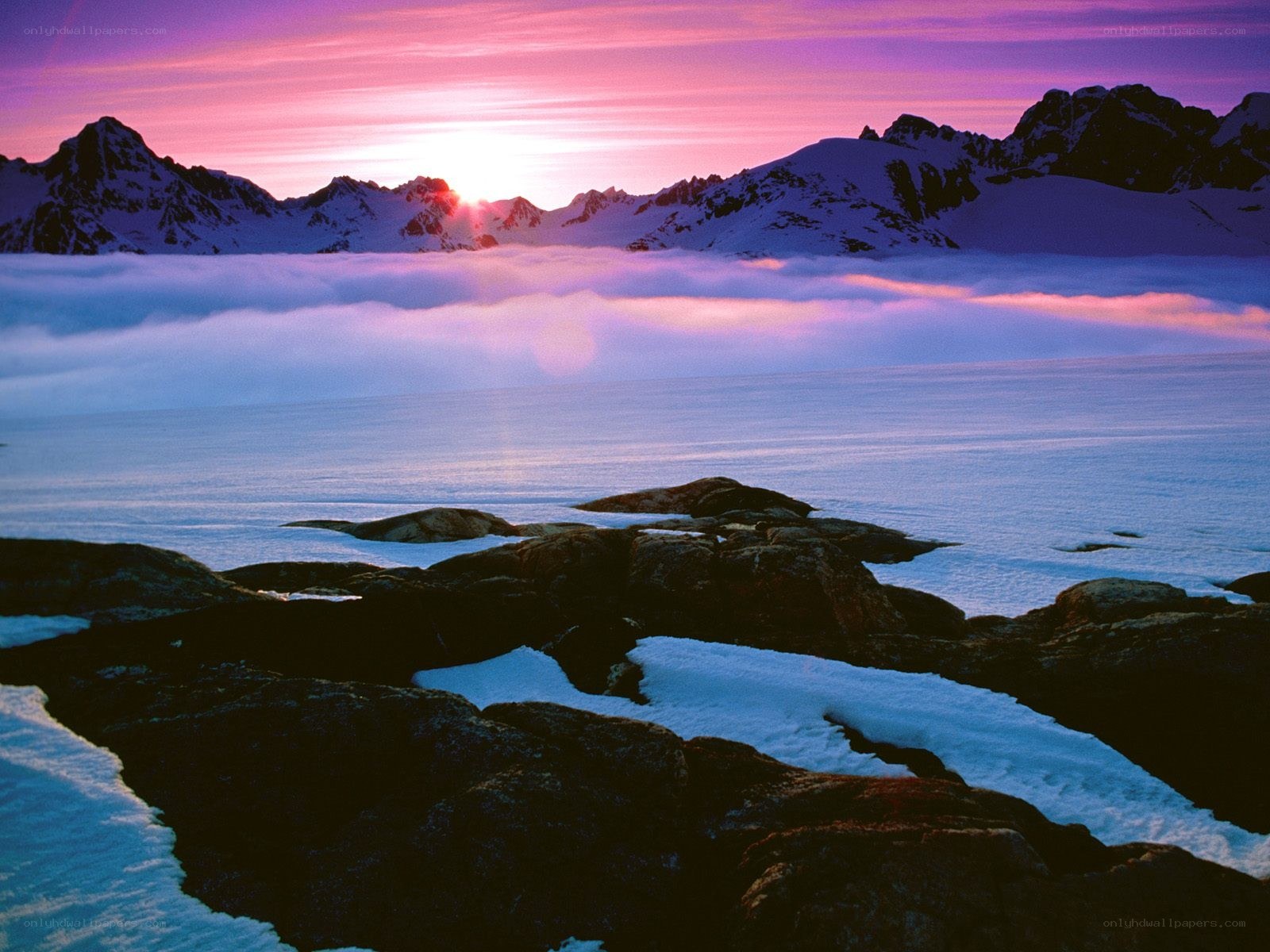 Sunset over snowy mountains