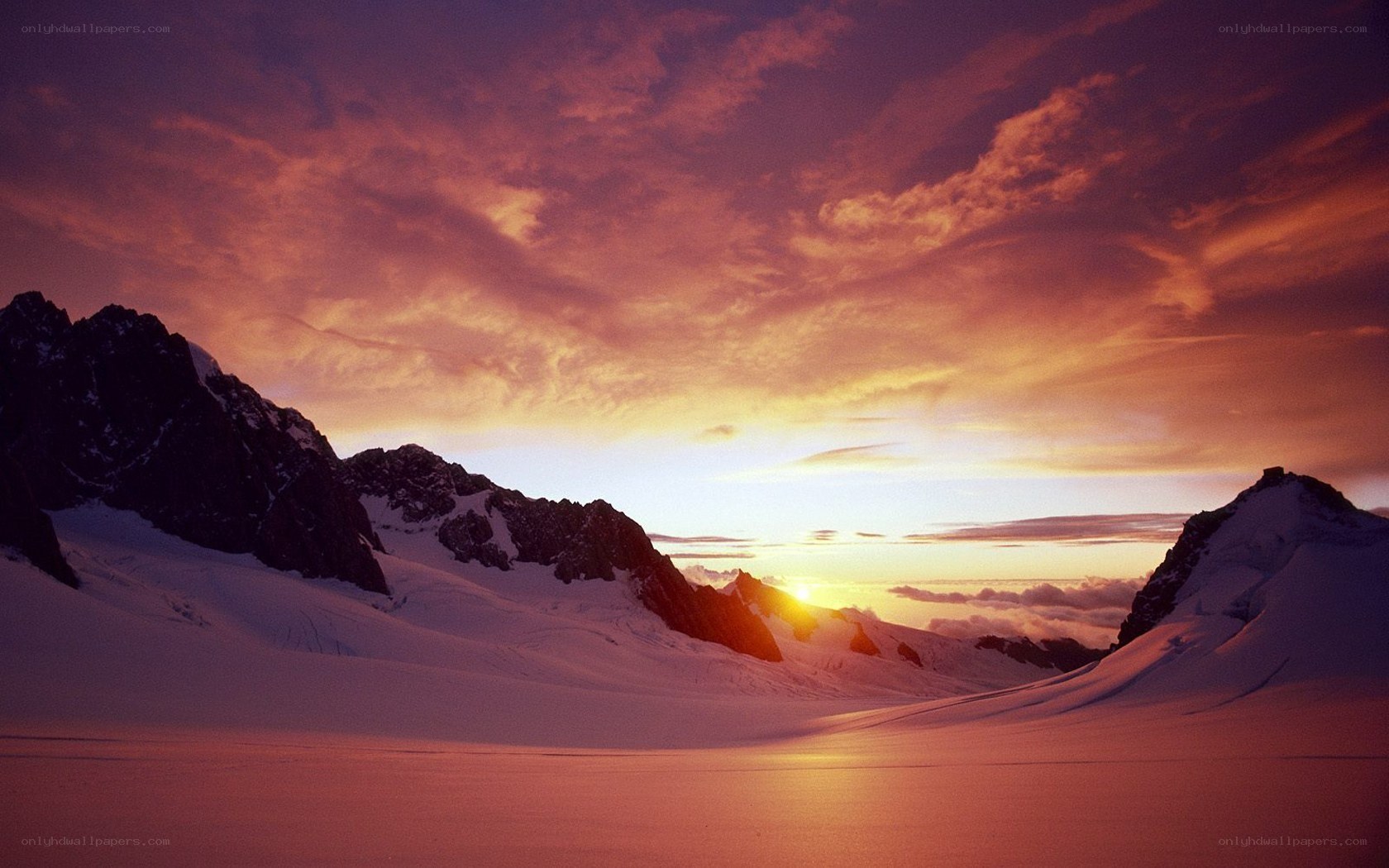 Sunset over snowy mountains