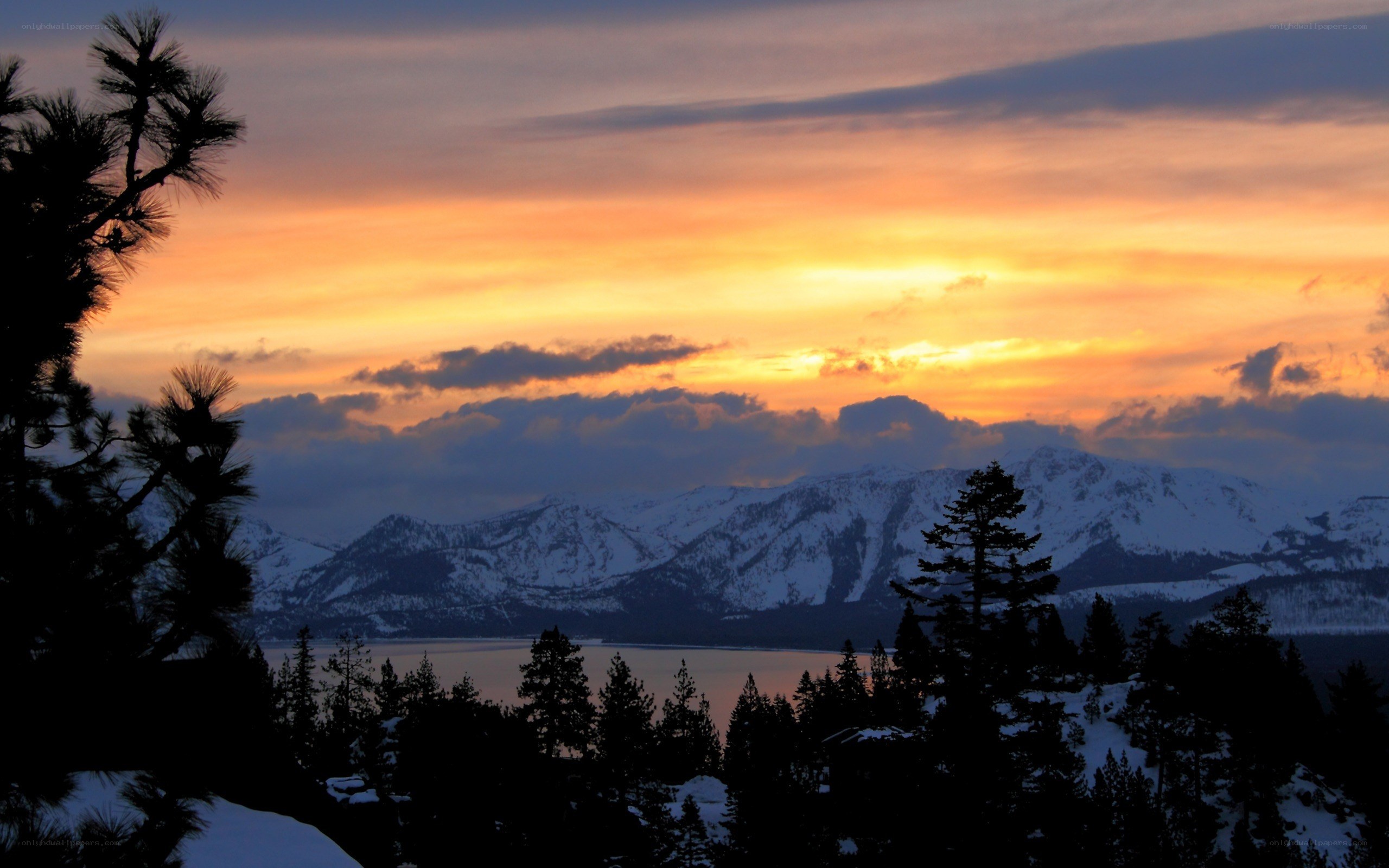 sunset over snowy mountains