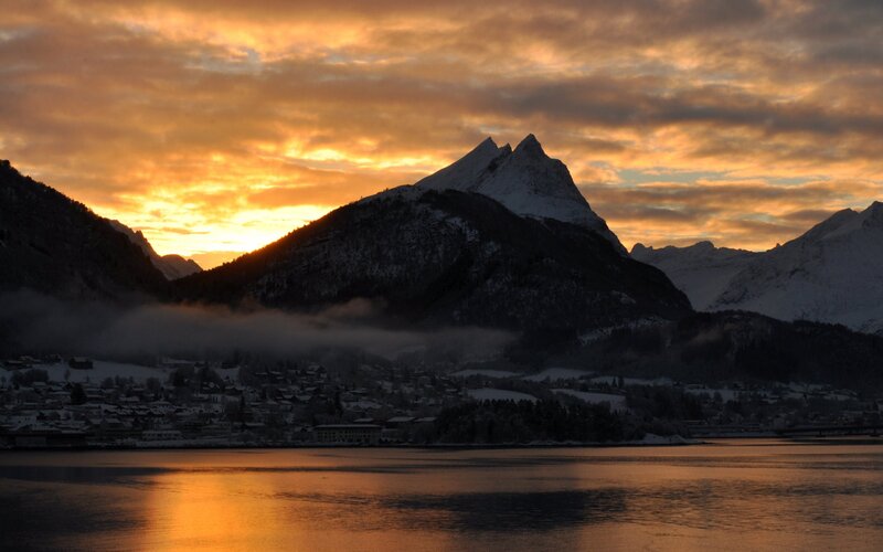 sunset over snowy mountains