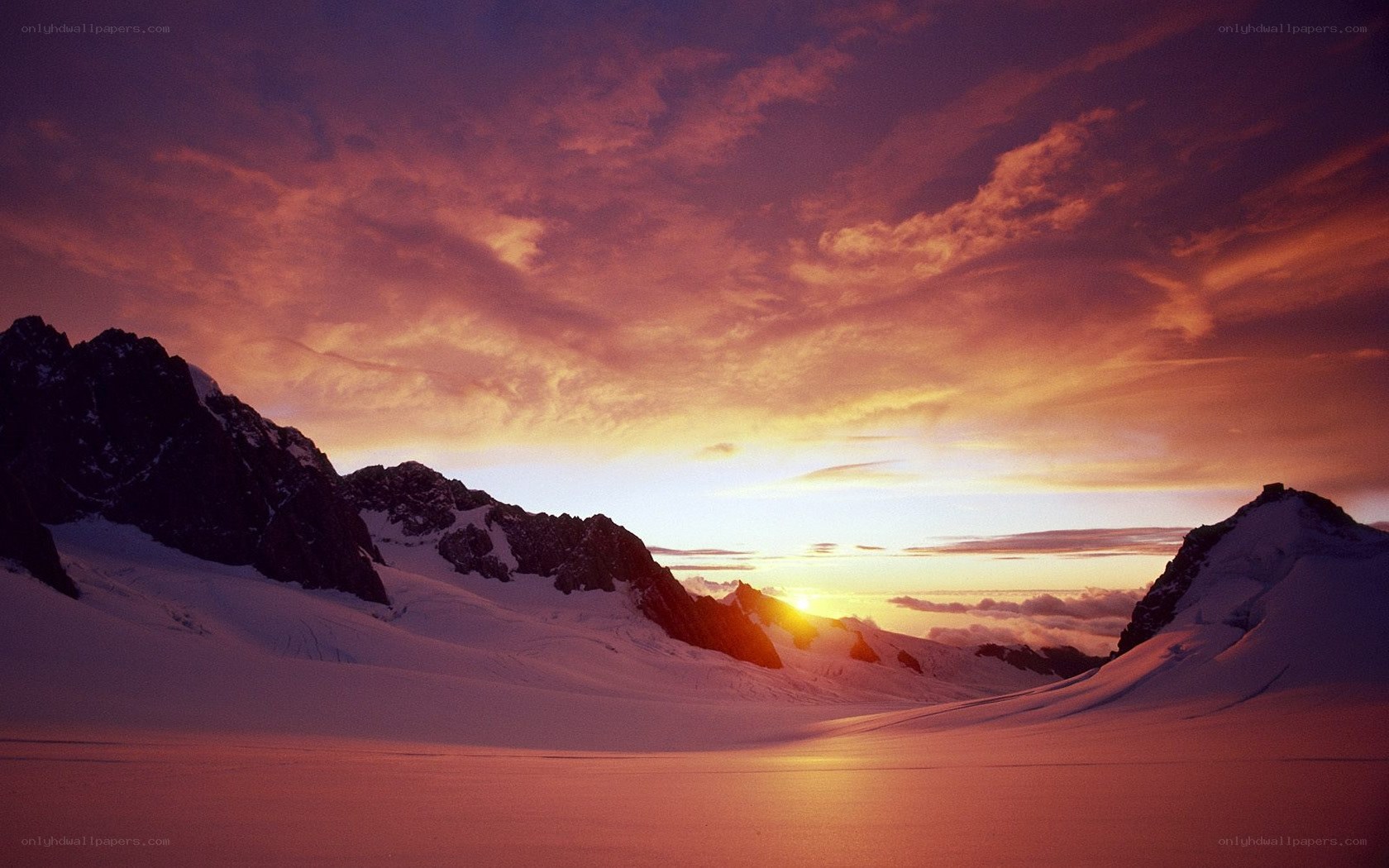 Sunset over snowy mountains