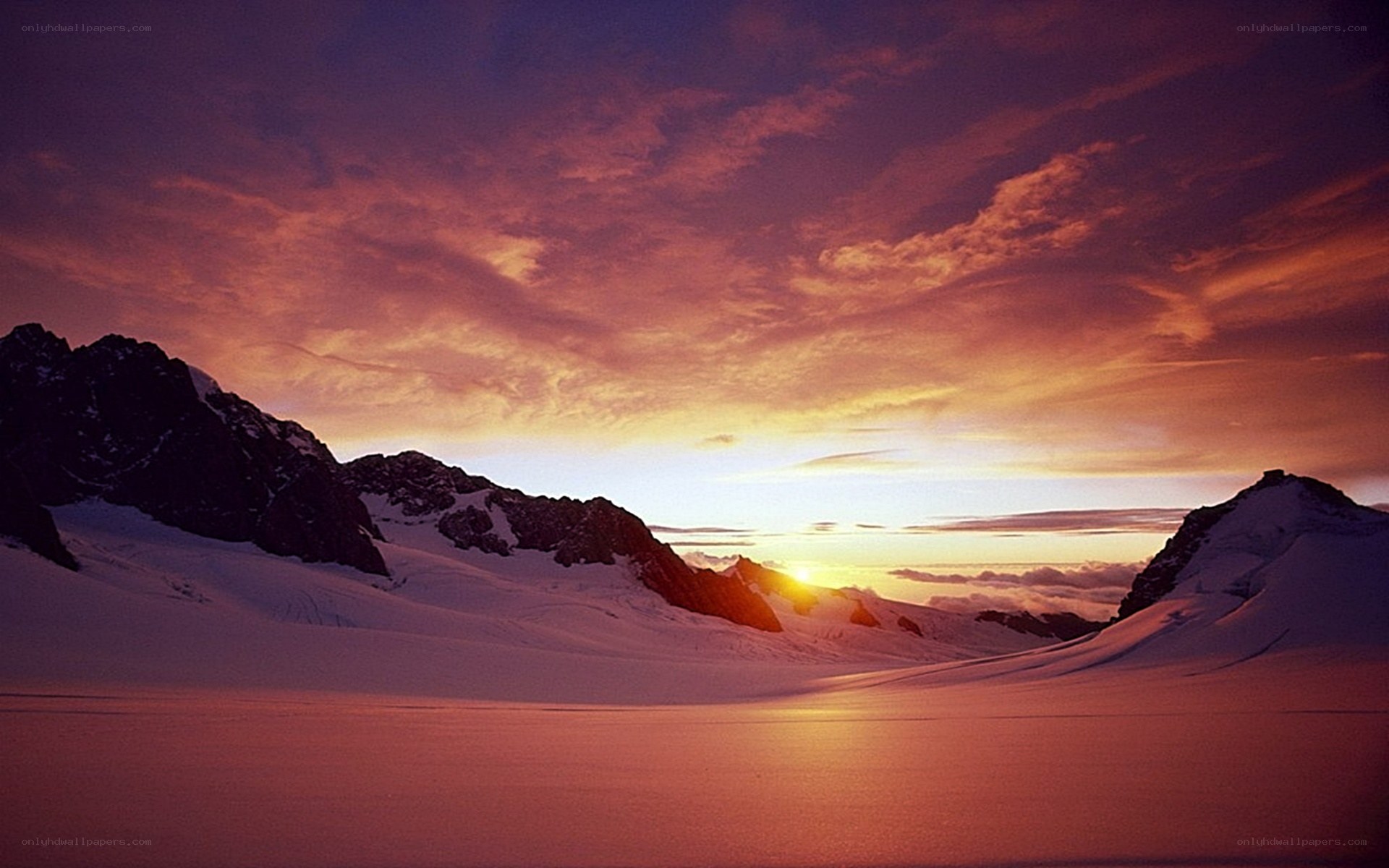 Sunset over snowy mountains