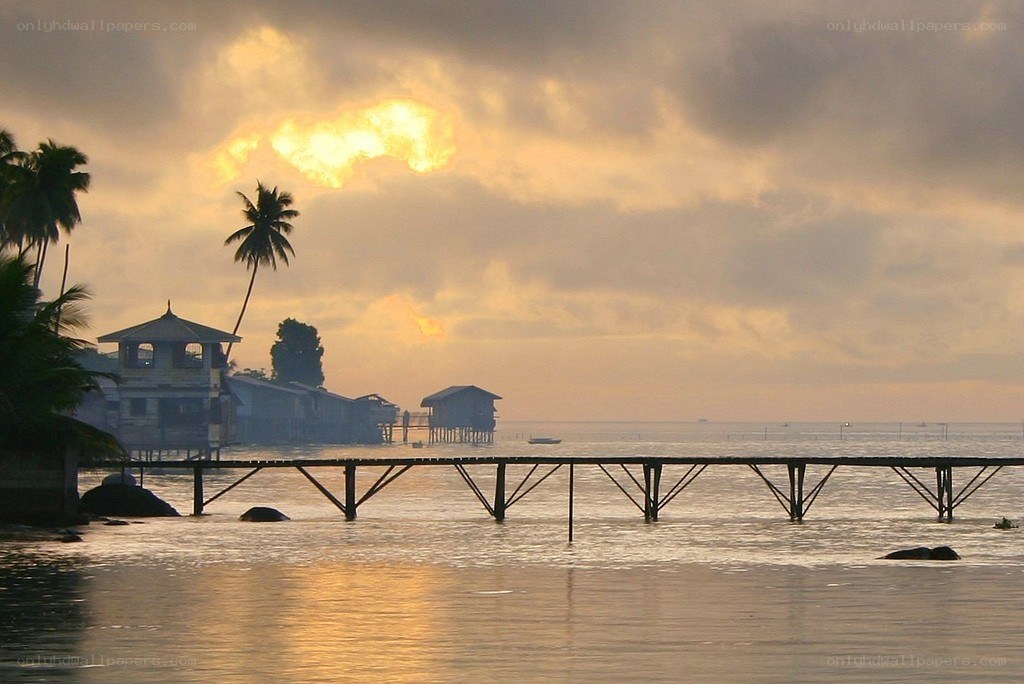 sunset over stilt houses