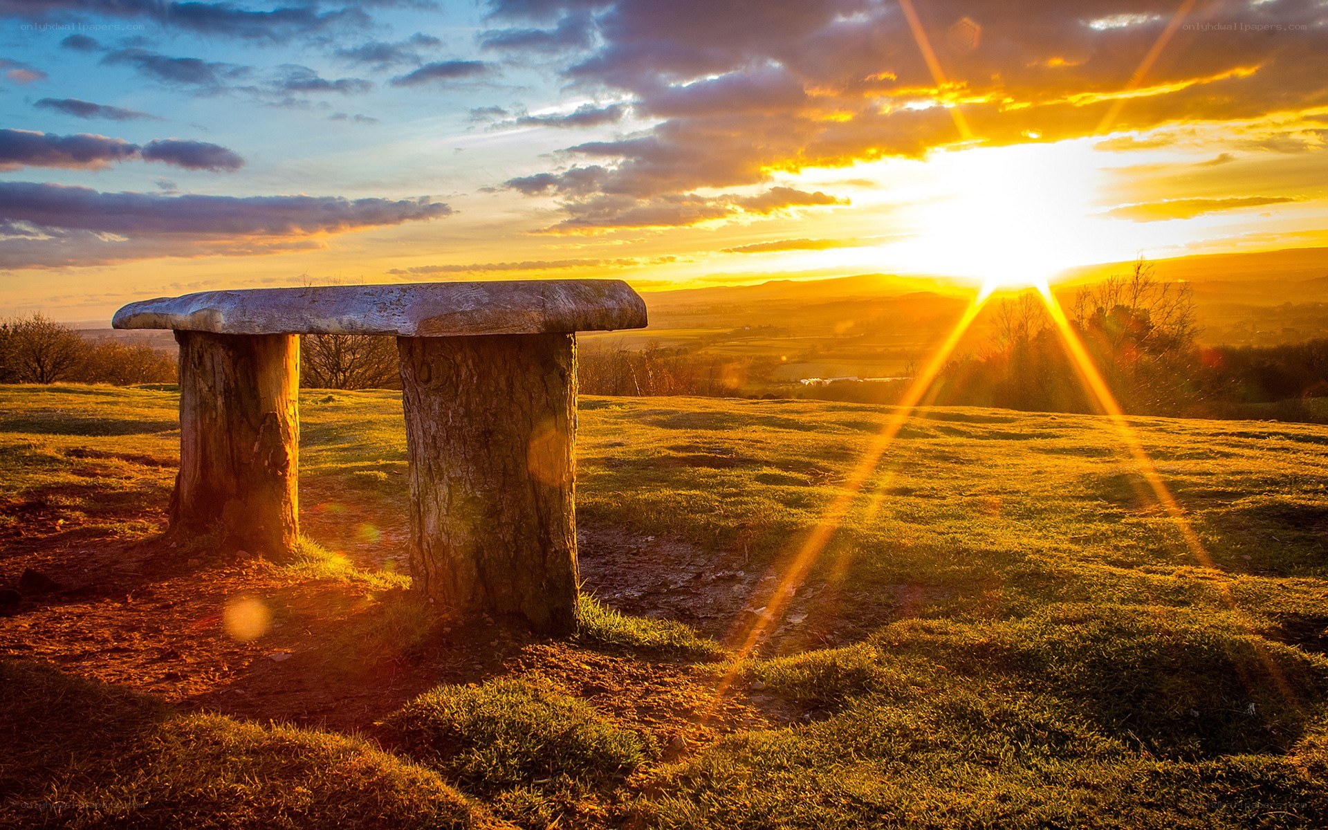 Sunset over stone bench