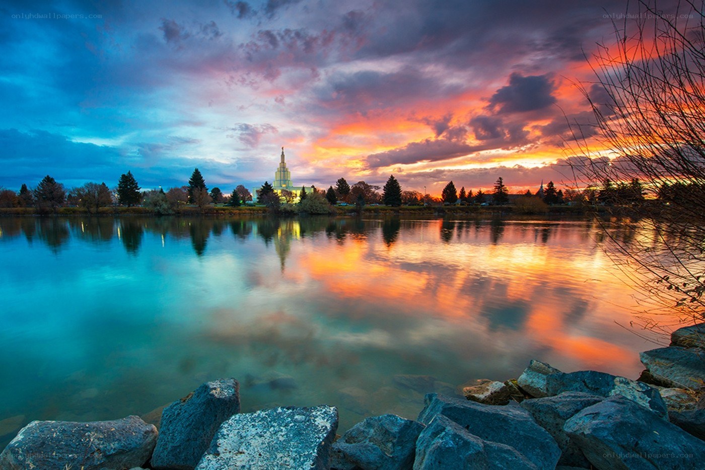 sunset over temple and lake