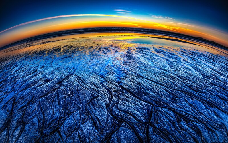 Sunset over textured beach