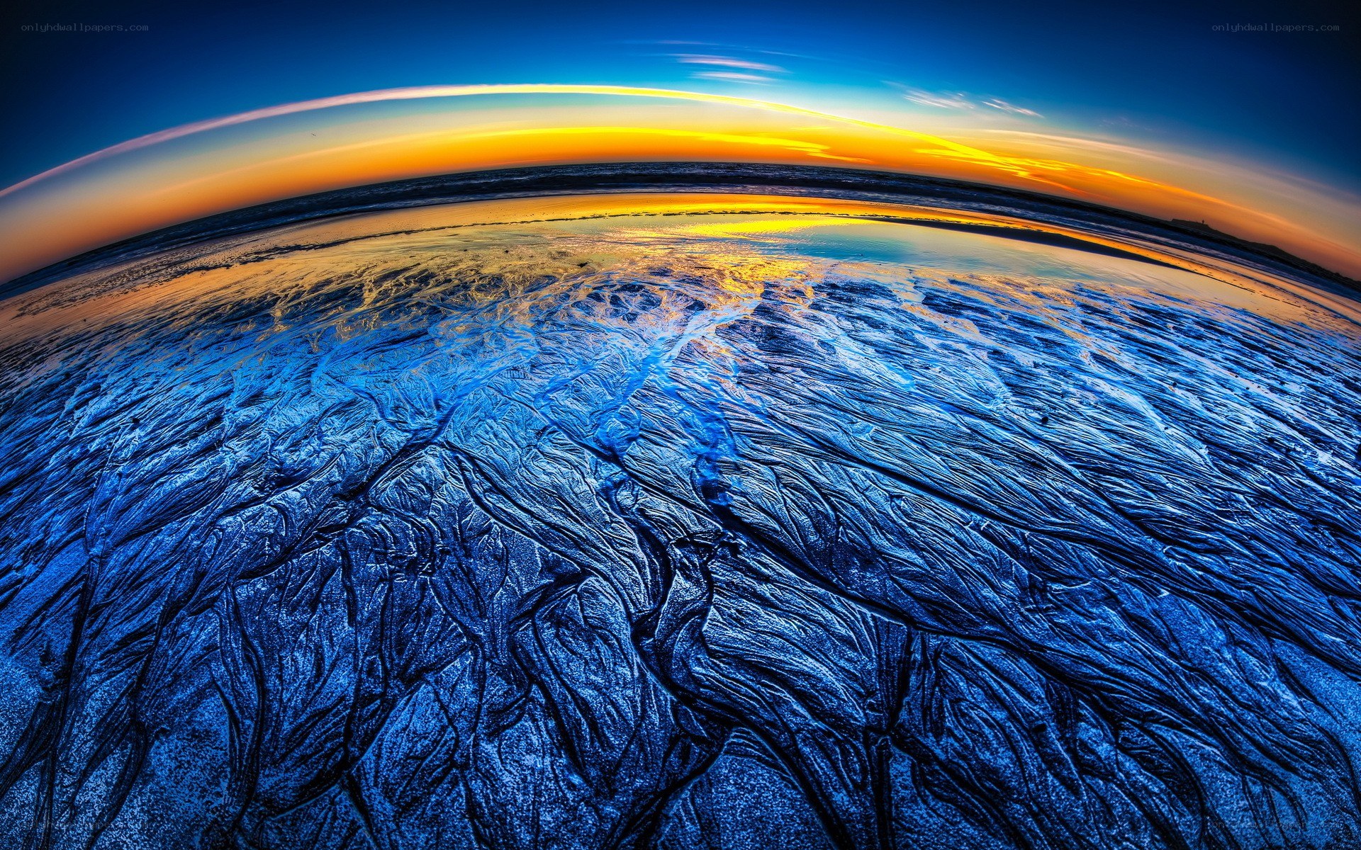 Sunset over textured beach