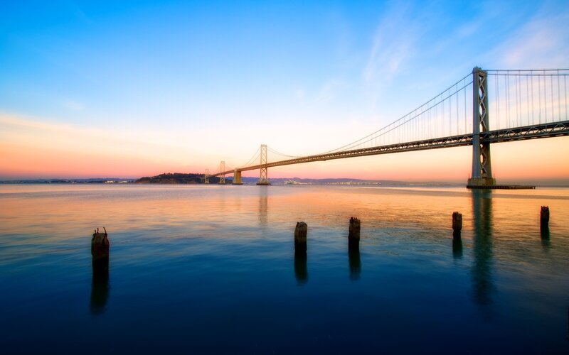 sunset over the bay bridge