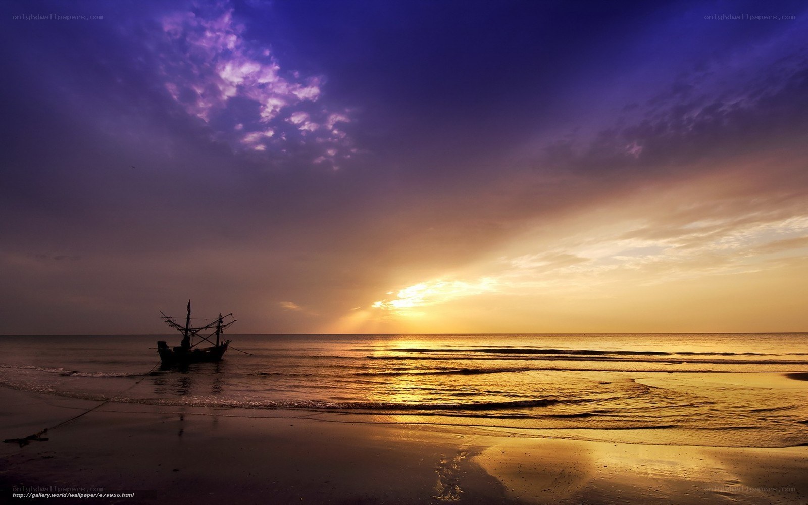 Sunset over the beach with a boat