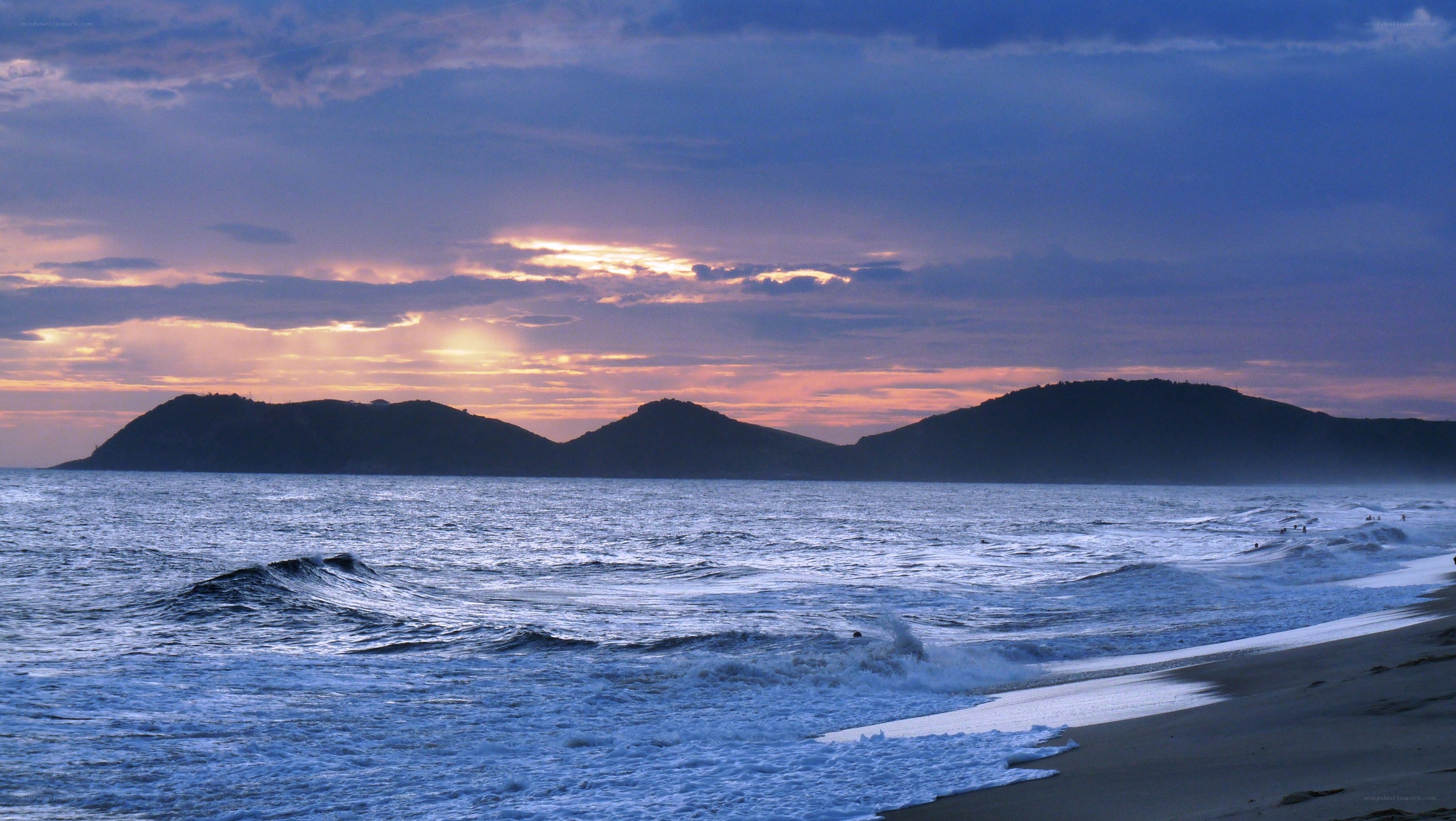 Sunset over the ocean and hills