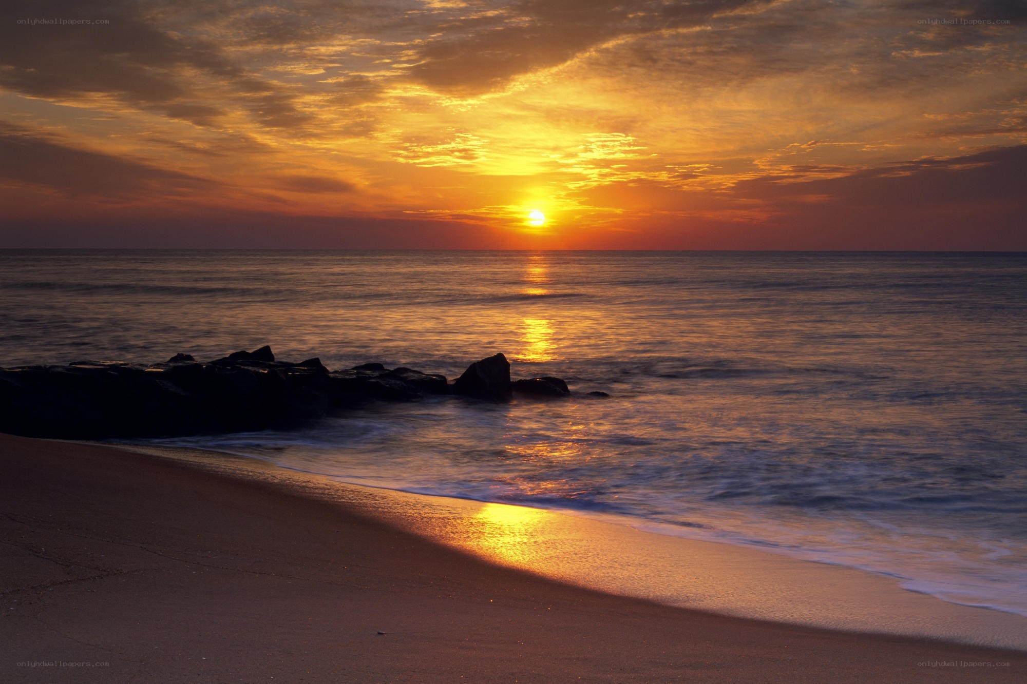 Sunset over the ocean beach