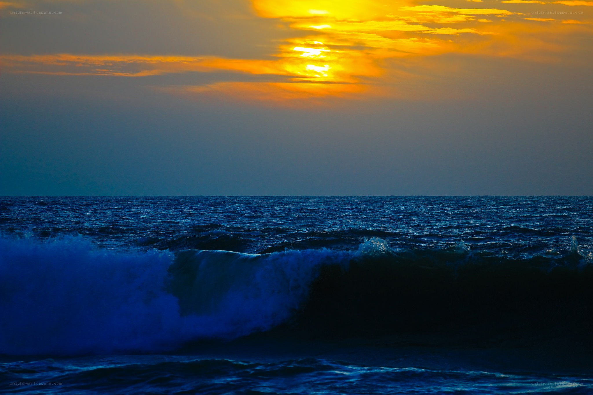 Sunset over the ocean waves