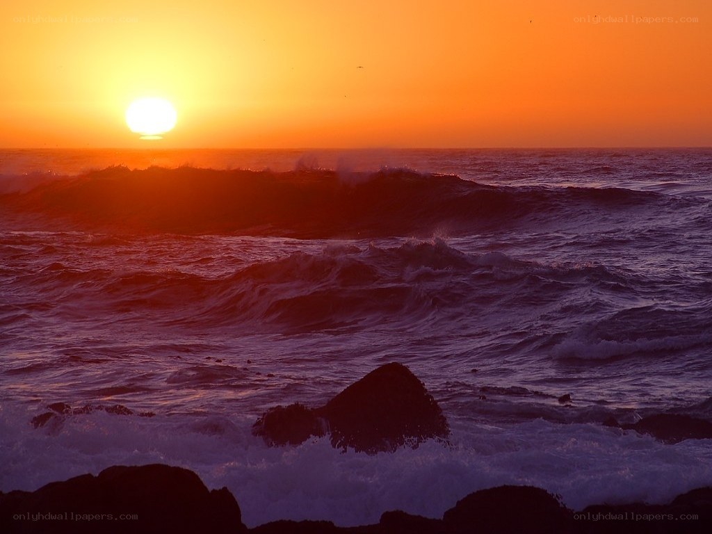 Sunset over the ocean waves
