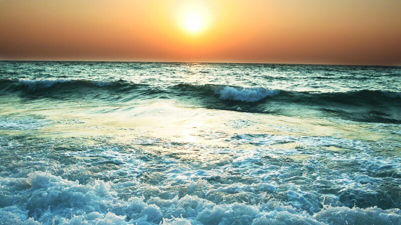 Sunset over the ocean waves