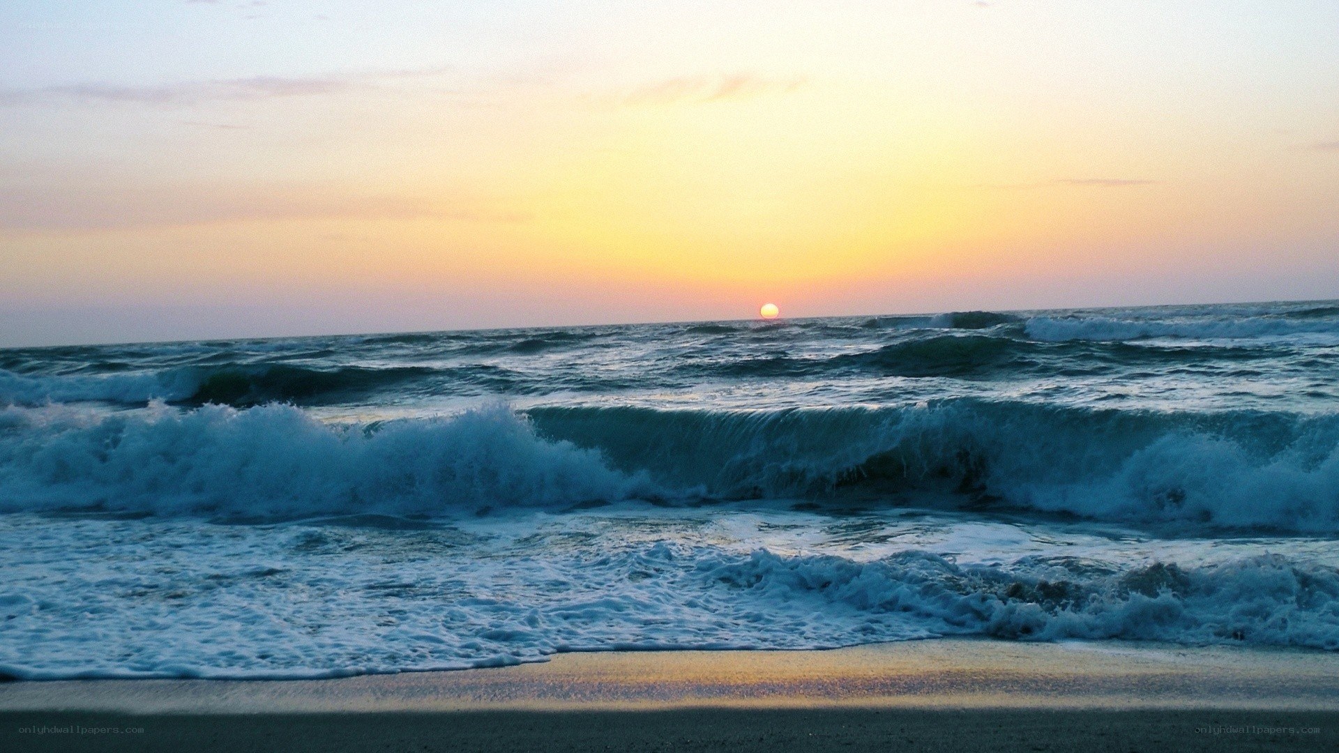 Sunset over the ocean waves