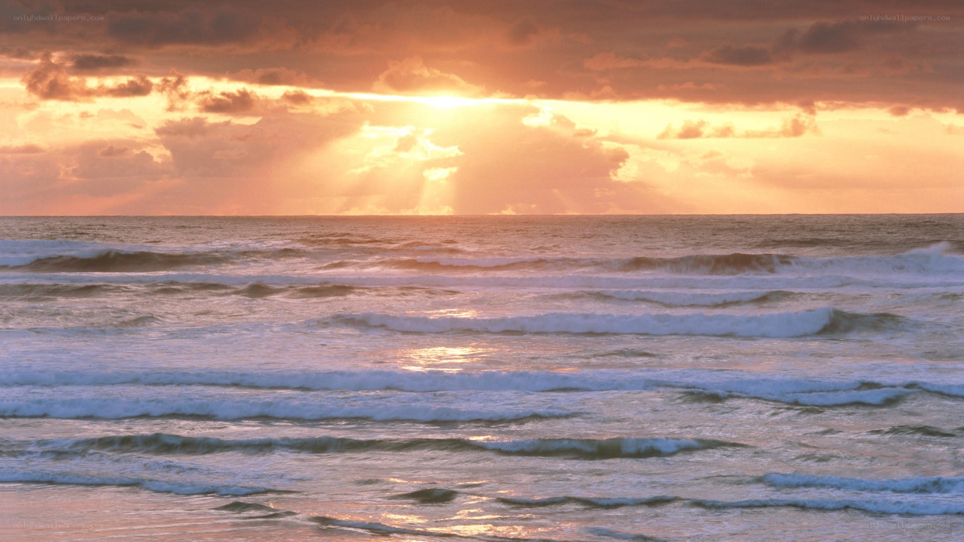 Sunset over the ocean waves