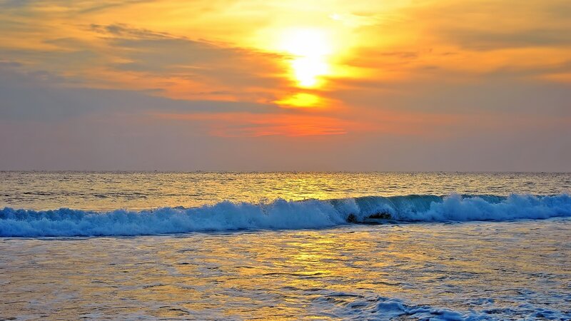 Sunset over the ocean waves