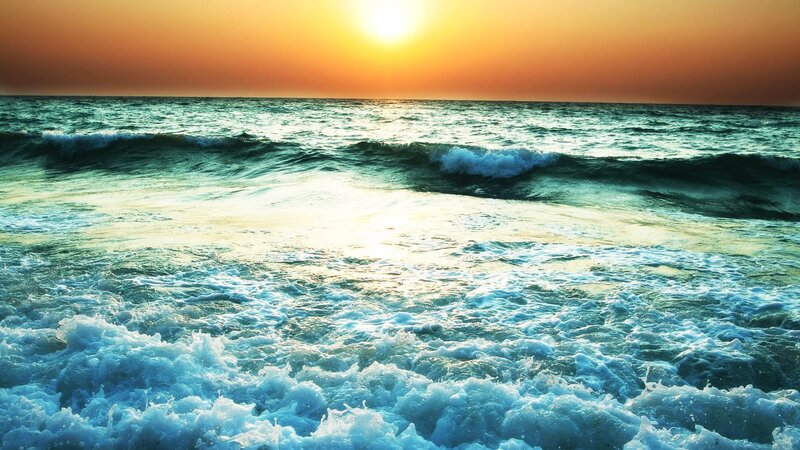 Sunset over the ocean waves