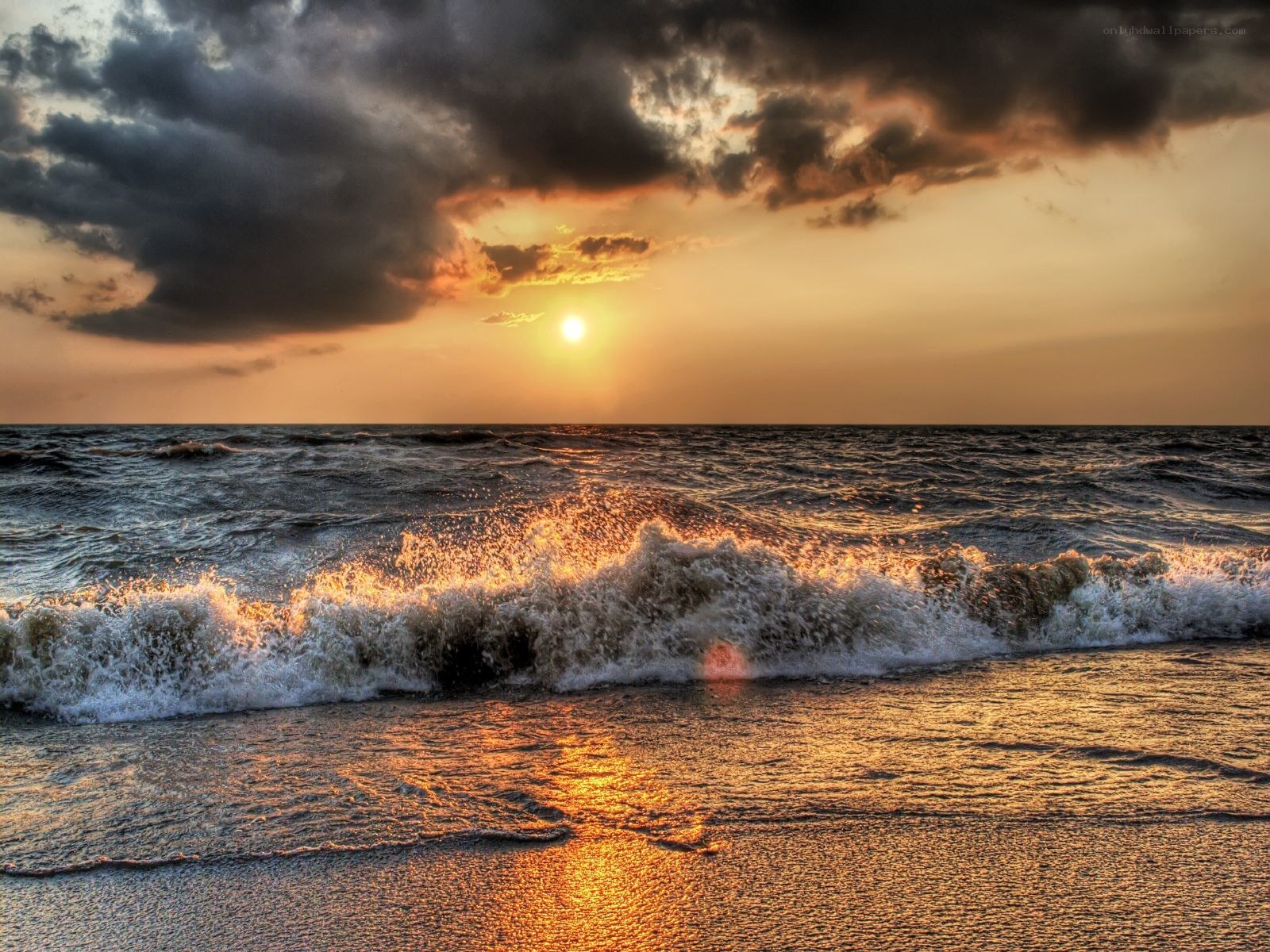 Sunset over the ocean waves