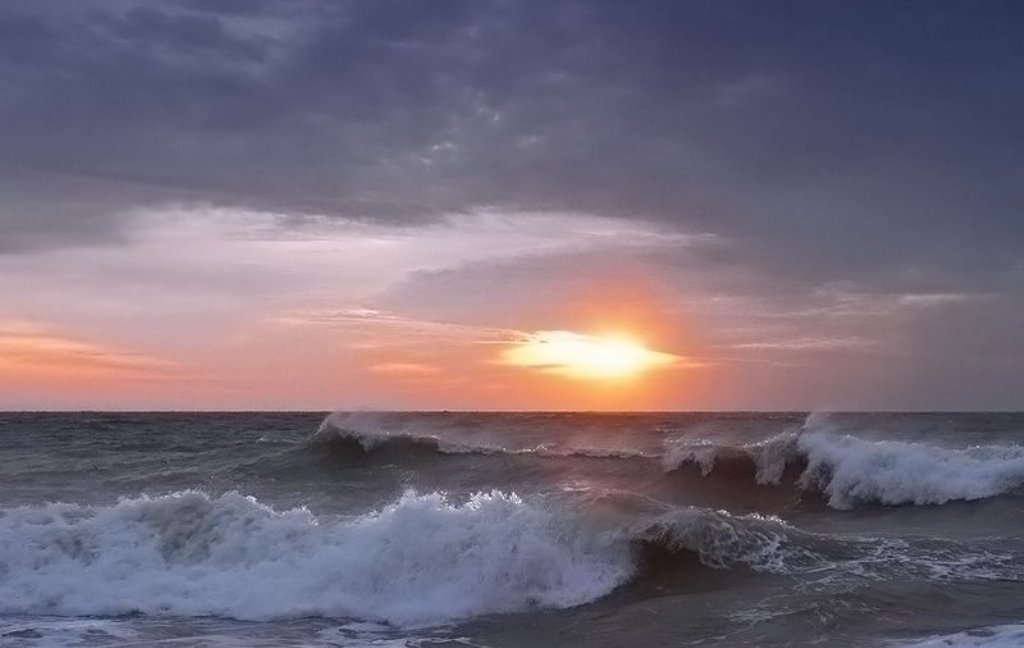 Sunset over the ocean waves