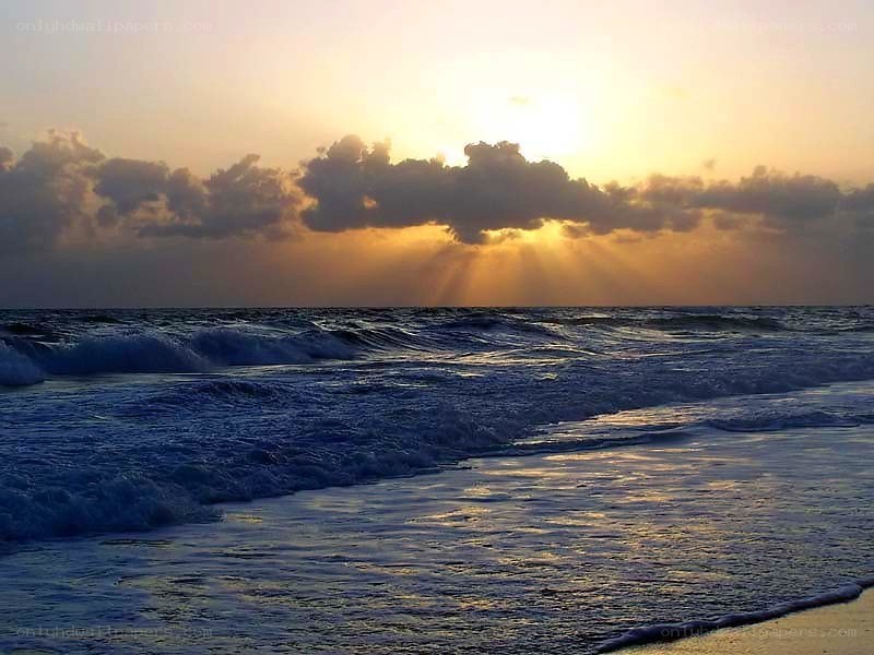 Sunset over the ocean waves