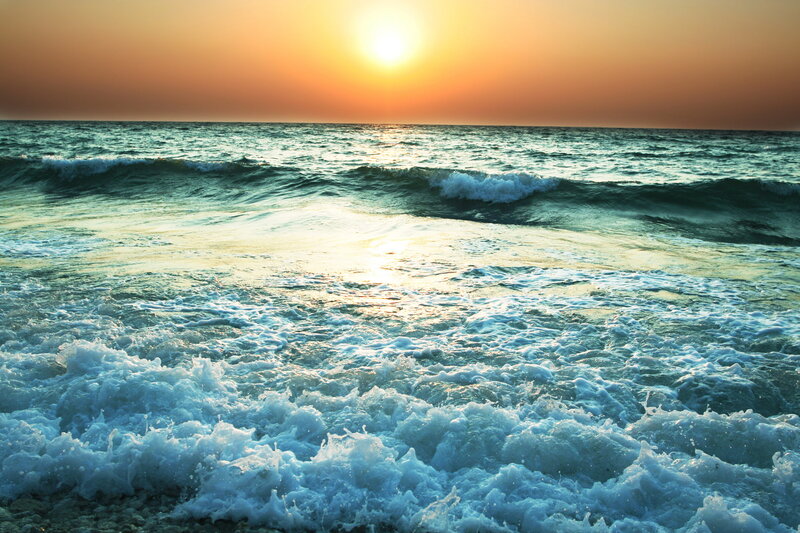 Sunset over the ocean waves