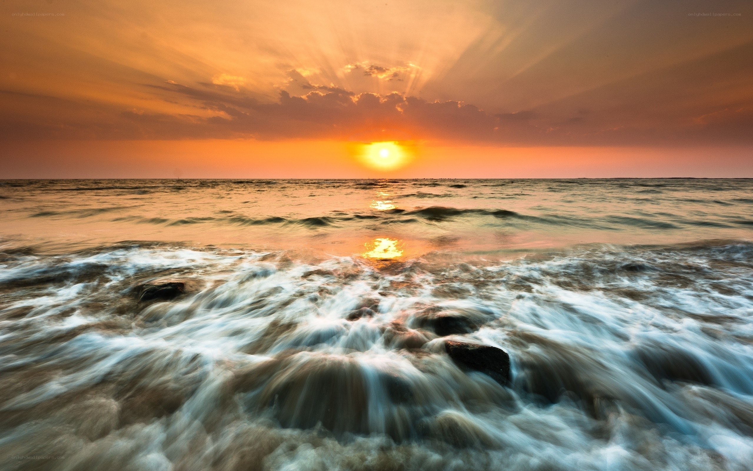 Sunset over the ocean waves