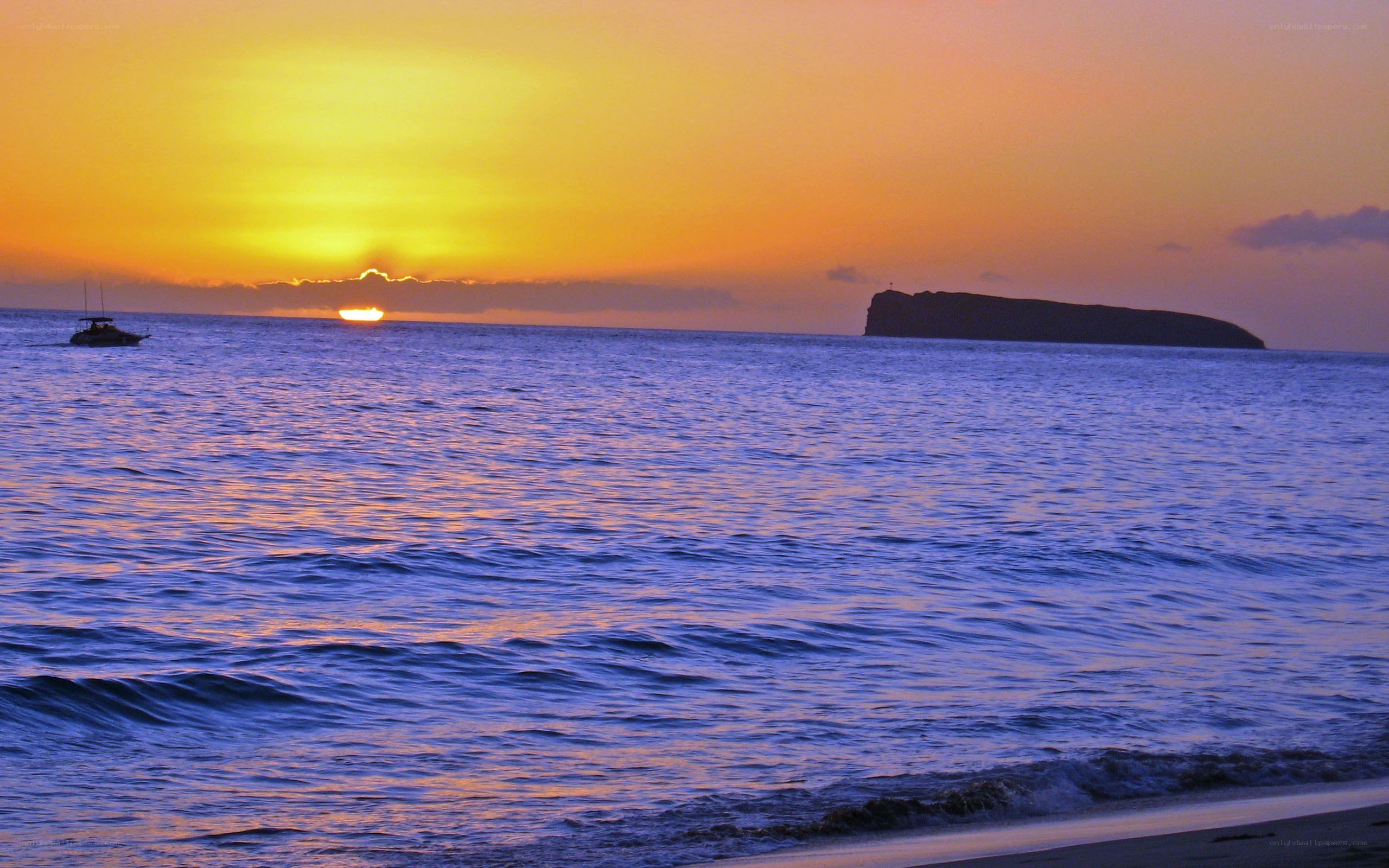 Sunset over the ocean with boat