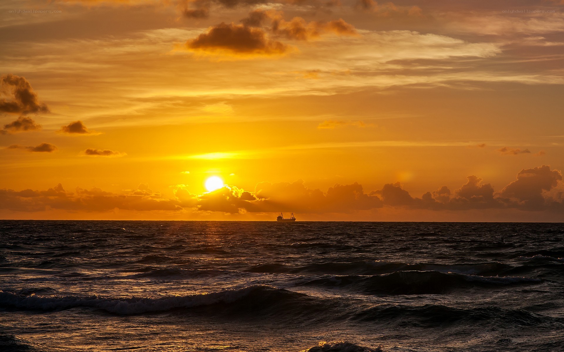 Sunset over the ocean with ship