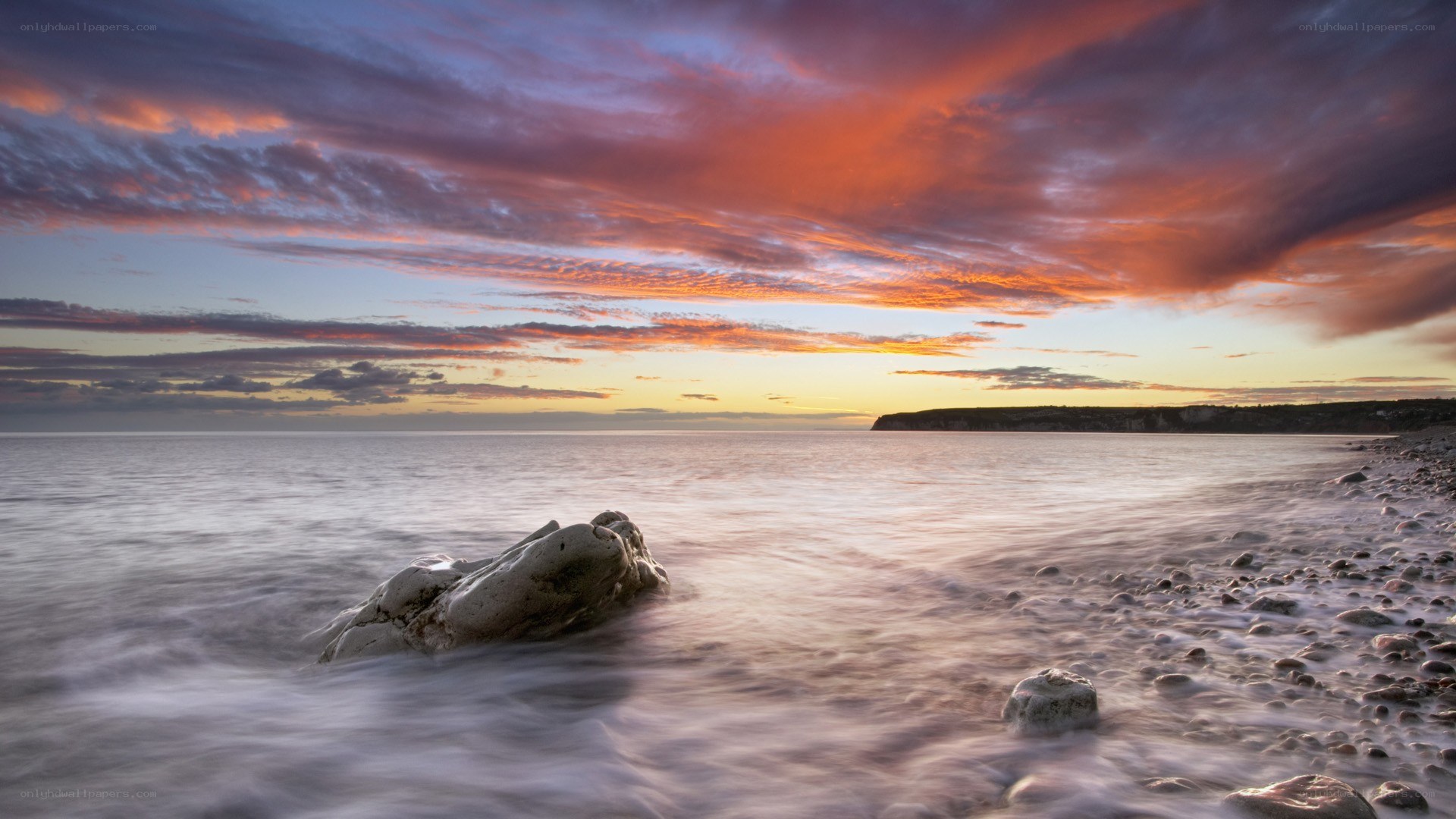 Sunset over the rocky beach