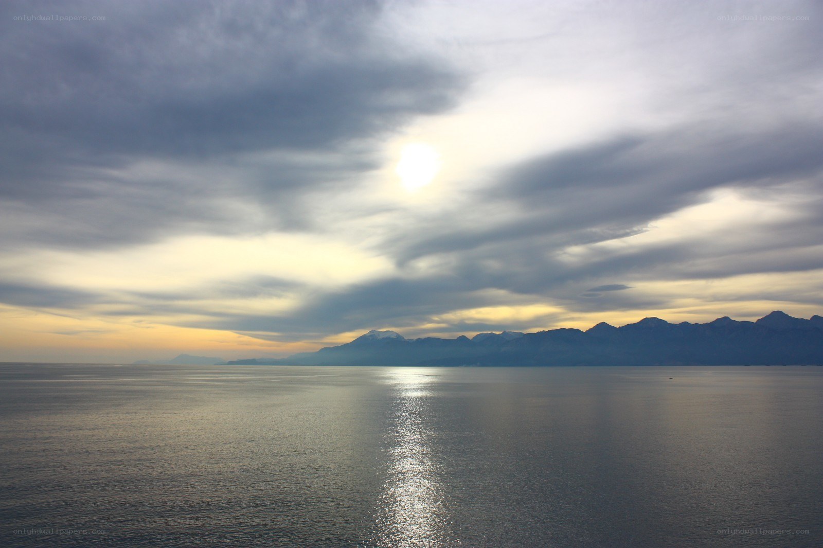 Sunset over the sea and mountains
