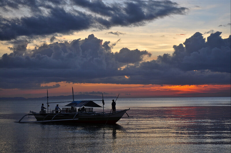 Sunset over the sea with a boat