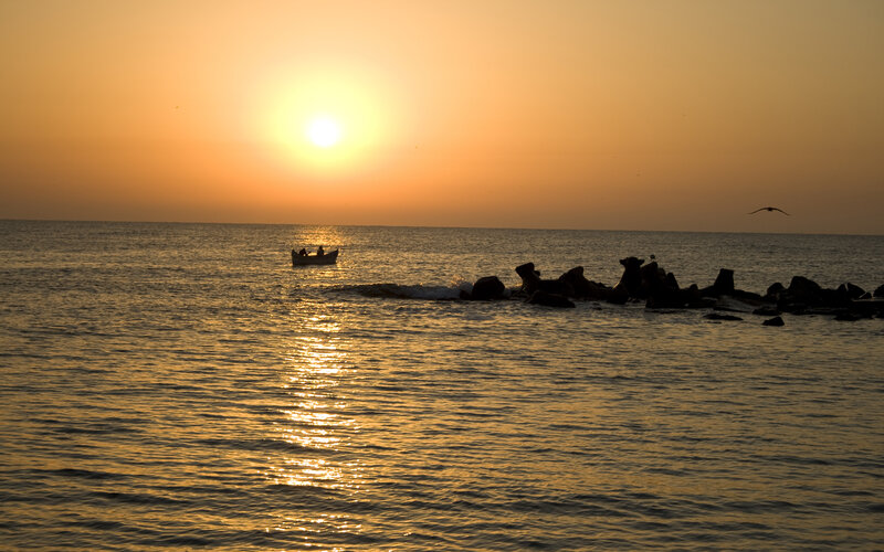 Sunset over the sea with a boat