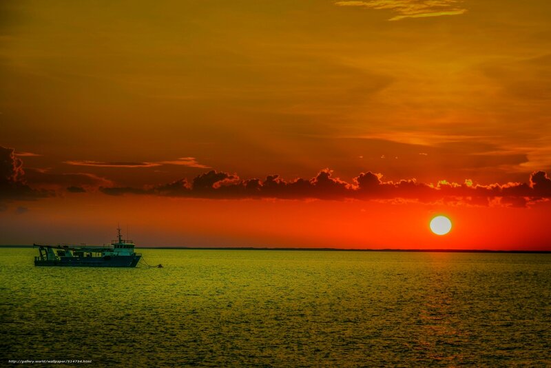 Sunset over the sea with a boat