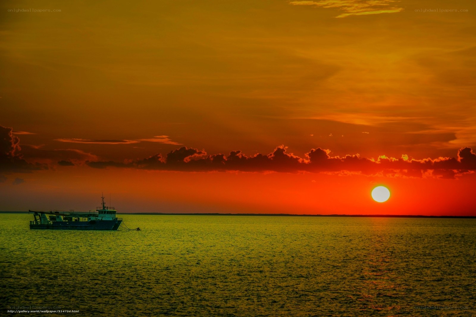 Sunset over the sea with a boat