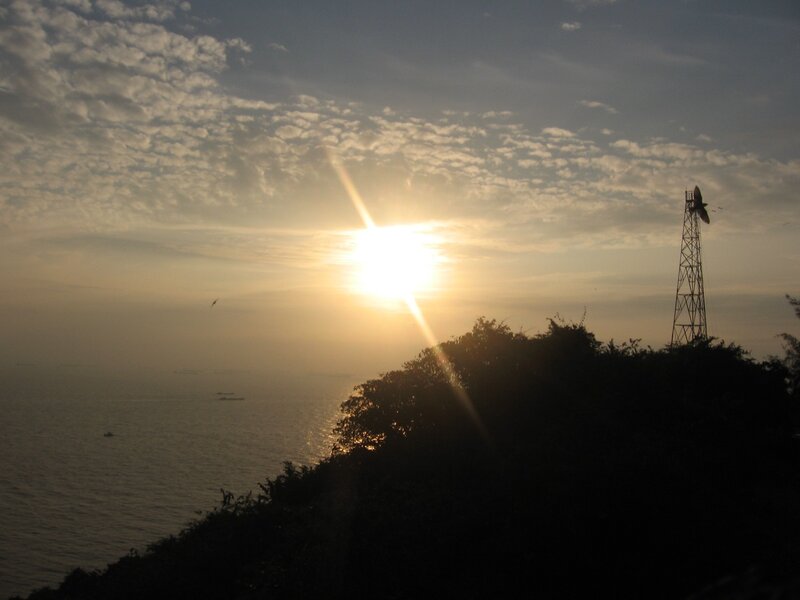 Sunset over the sea with a tower