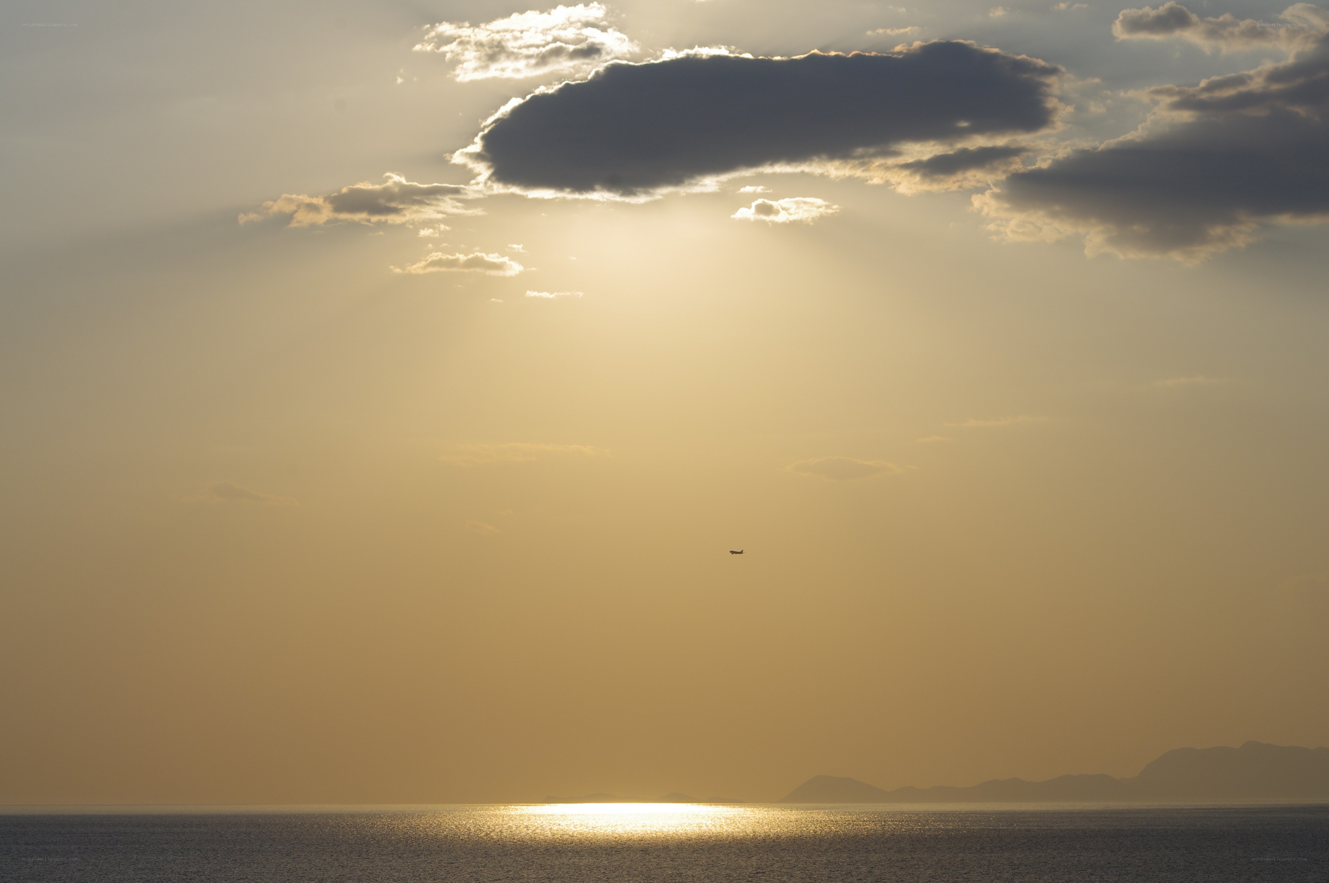 Sunset over the sea with airplane