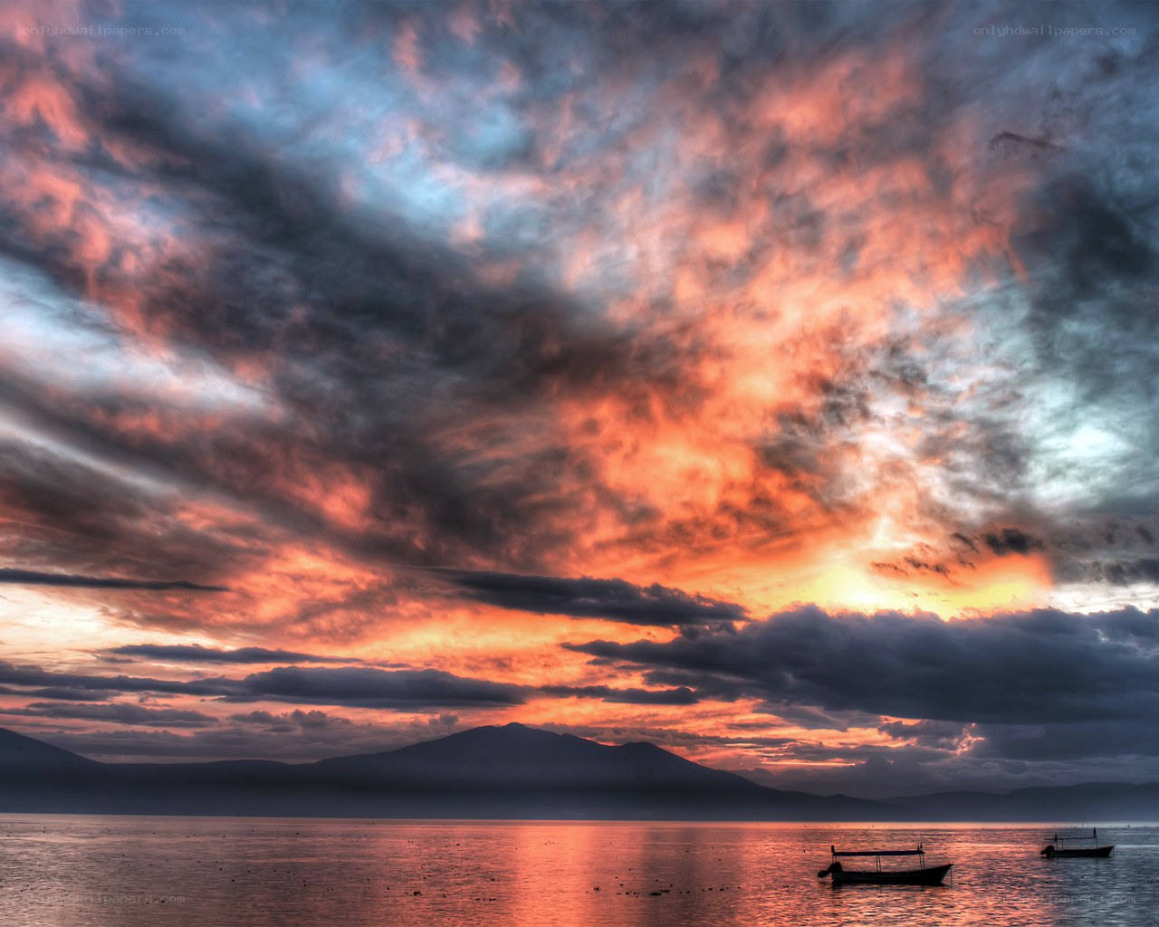 Sunset over the sea with boats