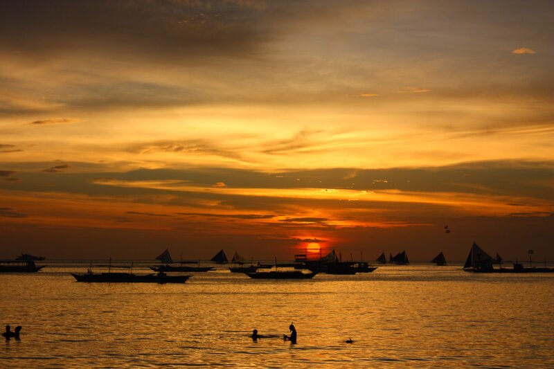 Sunset over the sea with boats
