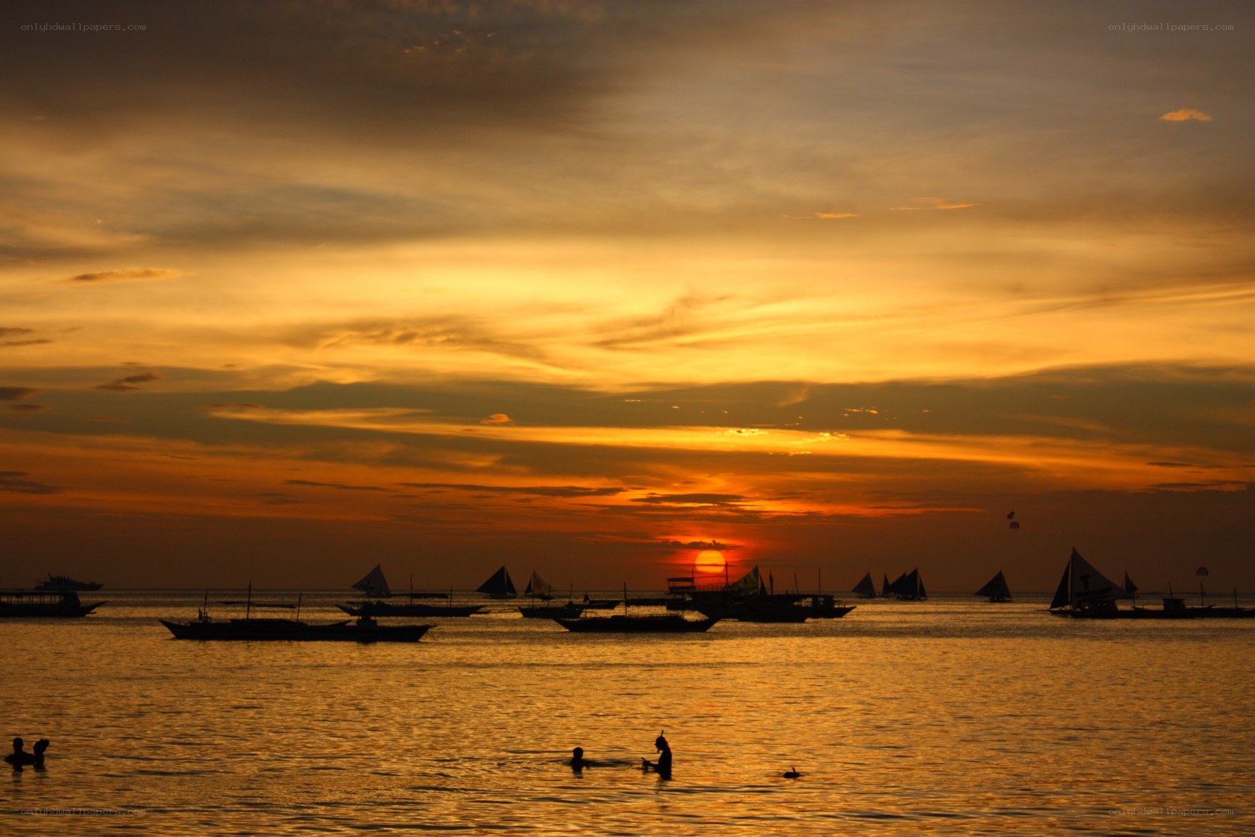 Sunset over the sea with boats