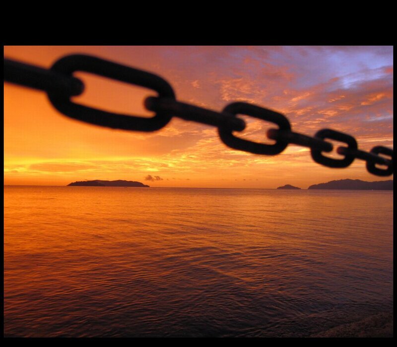 sunset over the sea with chain