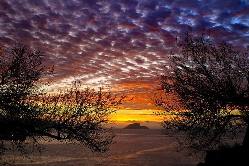 sunset over the sea with island