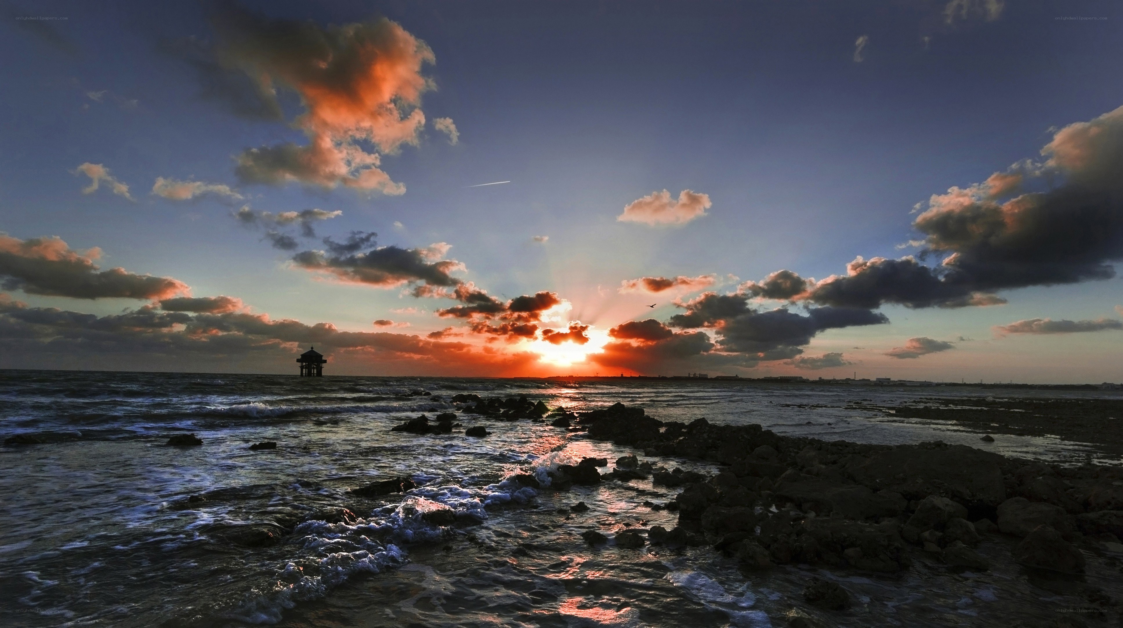Sunset over the sea with pier