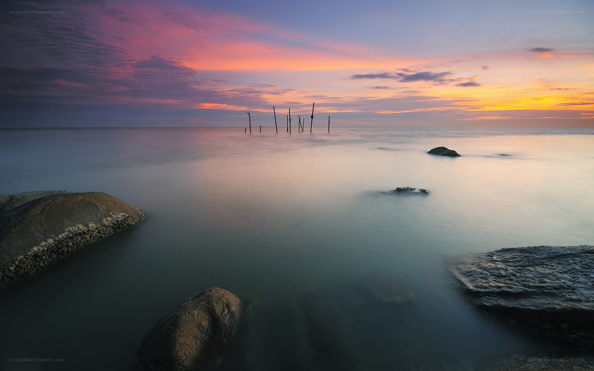 Sunset over the sea with rocks